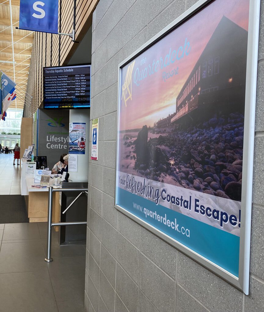 Wall-mounted advertisement display near Guest Services inside the LCLC.
